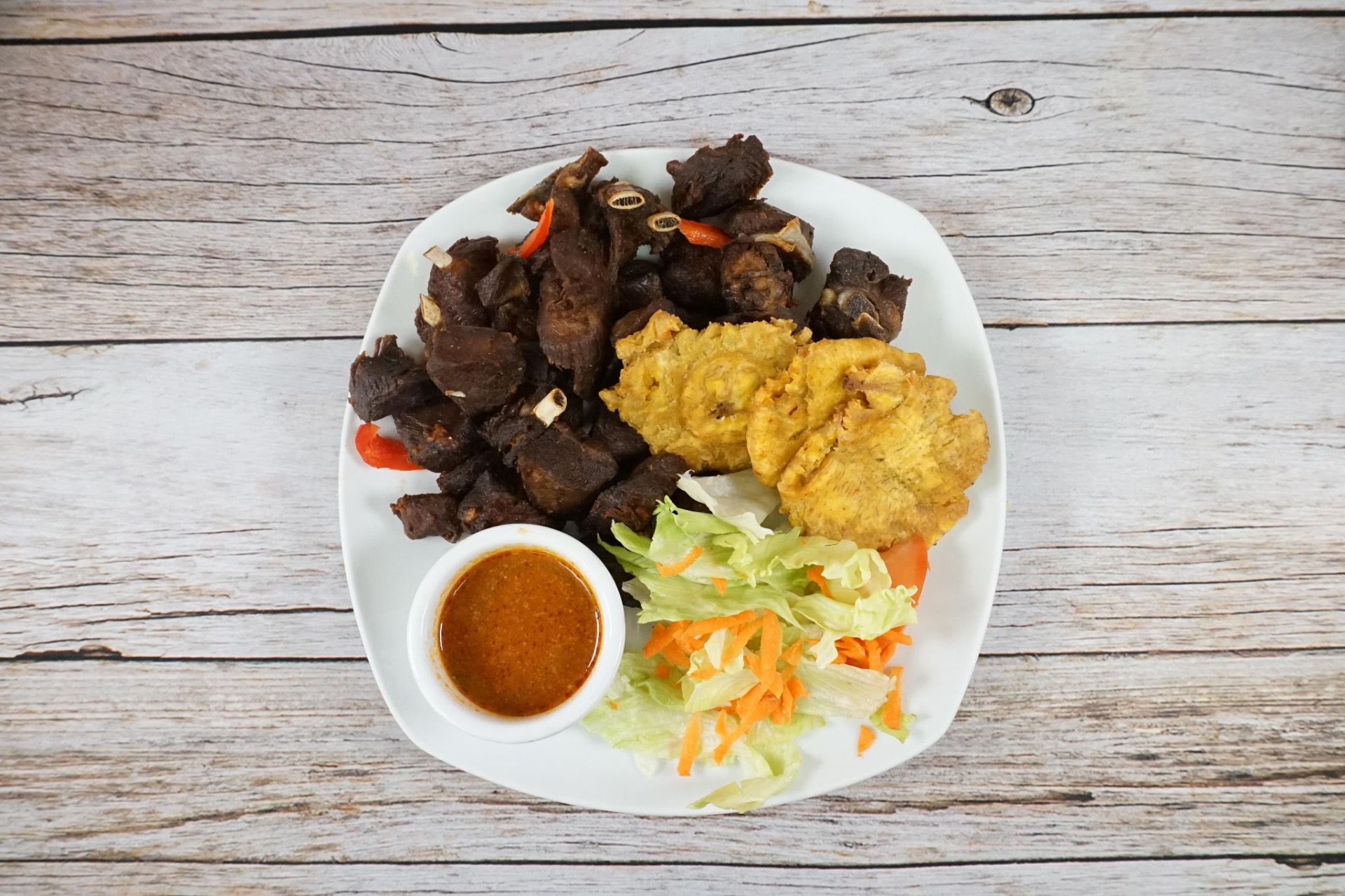 Fried Haitian goat (kabrit) with pikliz