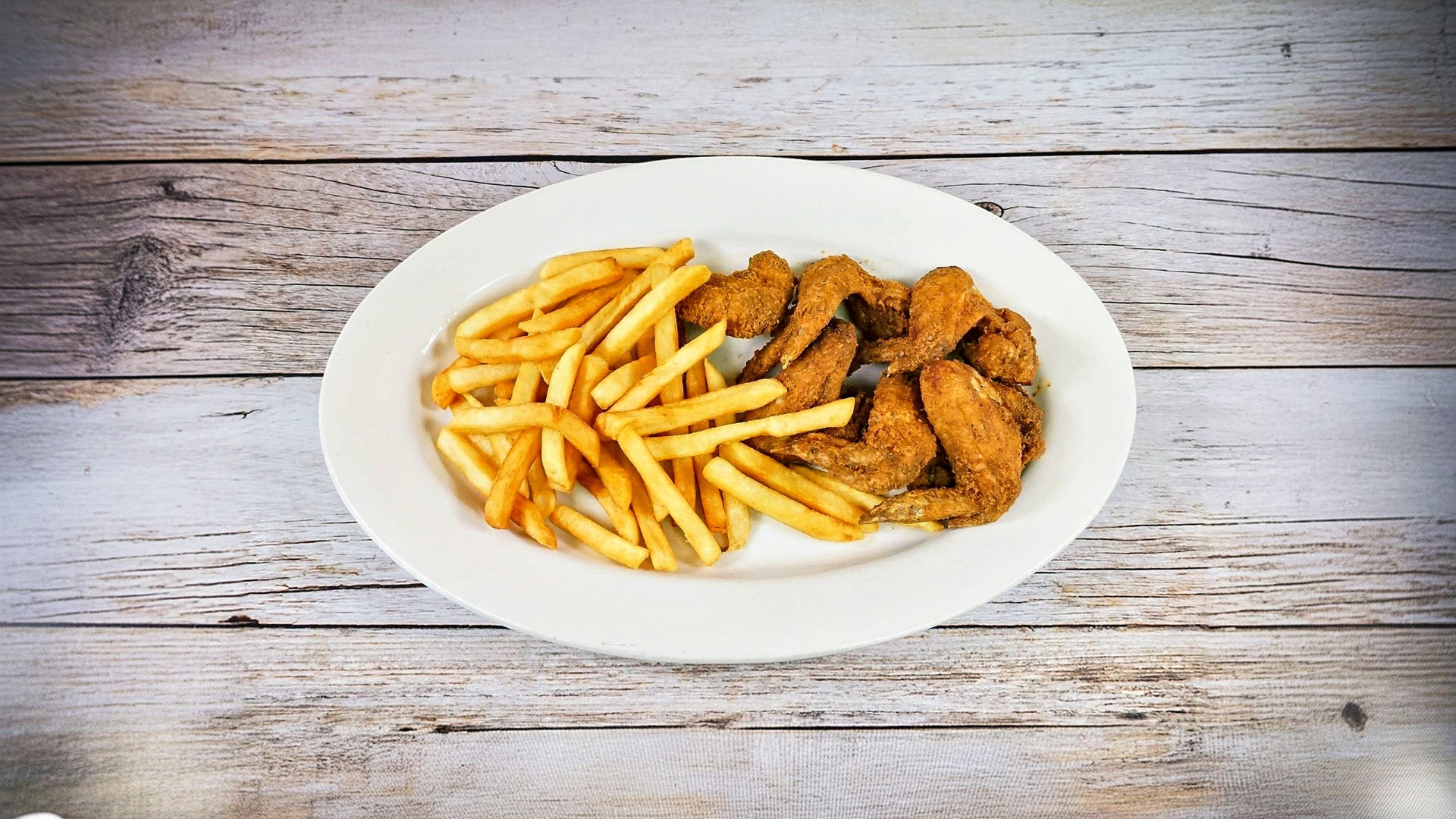 Crispy fried wings with fries
